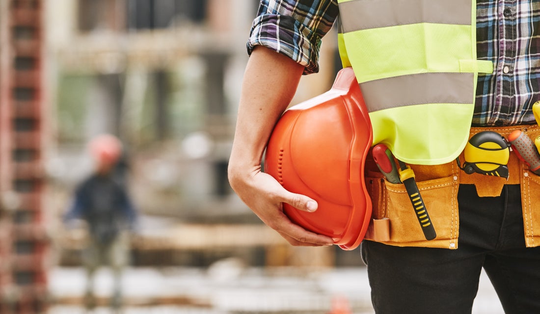 a construction worker holding a hard hat